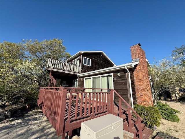 65 Lake Dr, Southold, NY 11971 - back of house featuring a chimney, a deck, and a balcony
