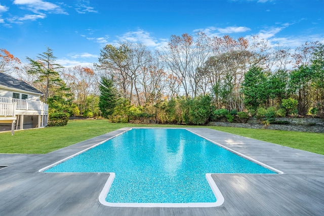 view of pool with a lawn