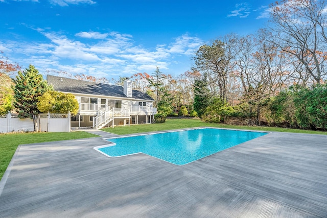 view of pool with a yard and a deck