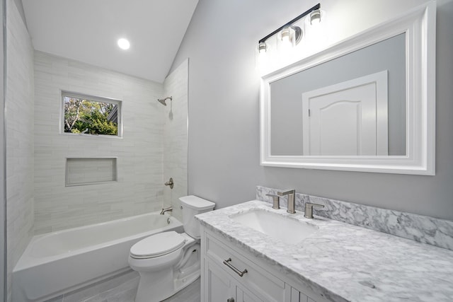 full bathroom with vanity, tiled shower / bath combo, vaulted ceiling, and toilet