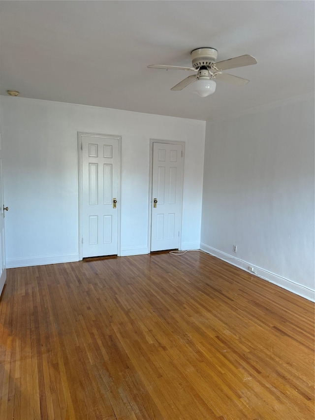 unfurnished bedroom featuring wood-type flooring and ceiling fan