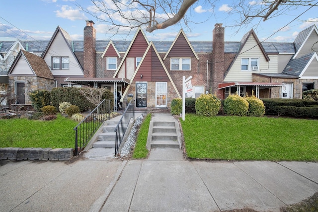 tudor house featuring a front yard