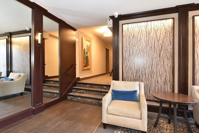 sitting room featuring crown molding and dark wood-type flooring