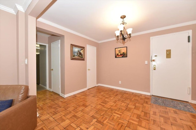 spare room with light parquet floors, a chandelier, and ornamental molding