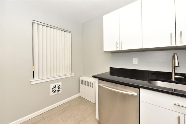 kitchen featuring white cabinetry, dishwasher, sink, and radiator heating unit