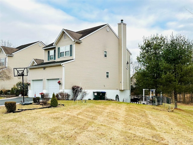 rear view of house featuring a garage and a yard