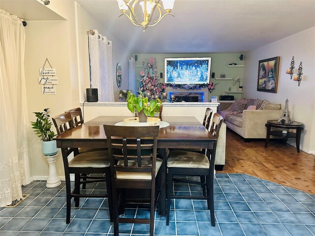 dining space featuring dark wood-type flooring and a chandelier