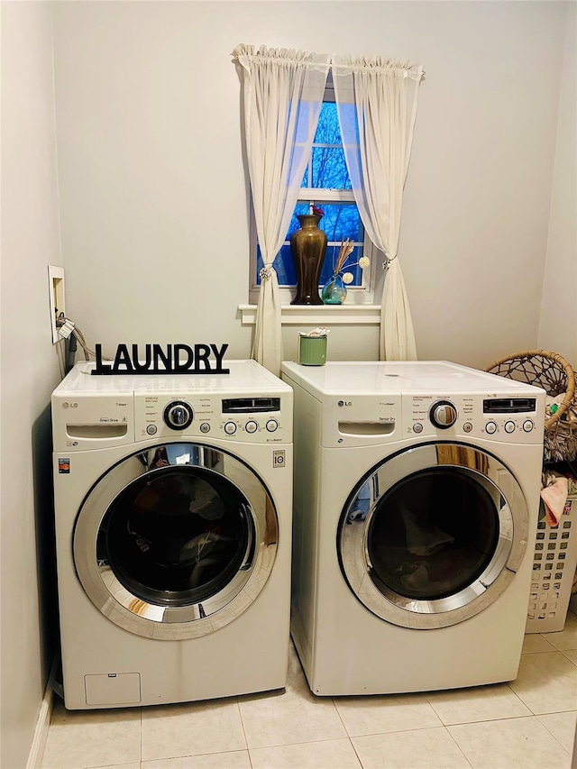 washroom with light tile patterned flooring and independent washer and dryer