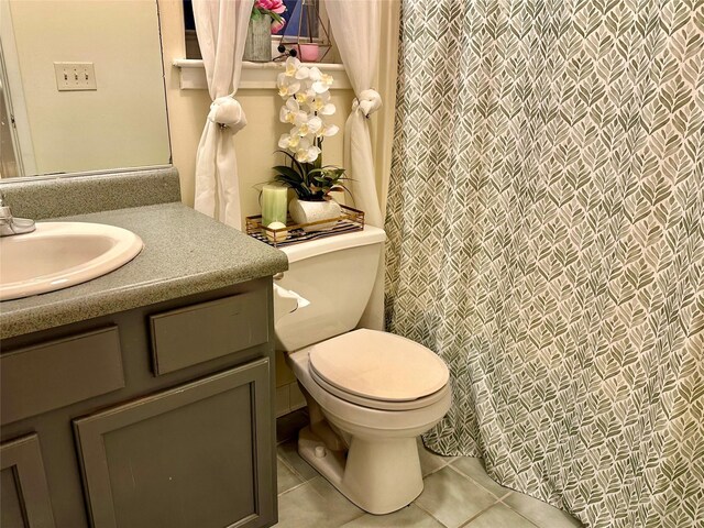 bathroom with tile patterned floors, vanity, and toilet