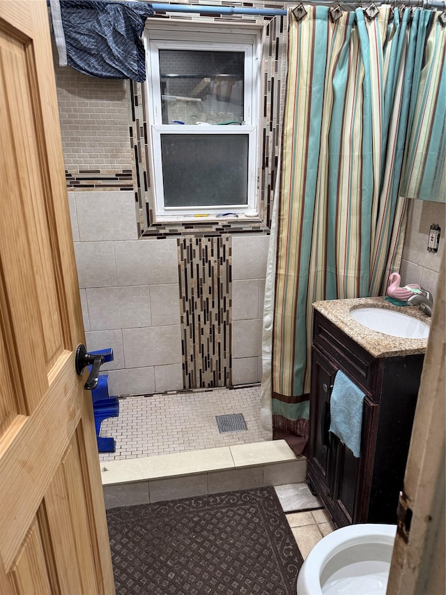 bathroom with tile patterned flooring, a shower with curtain, vanity, and toilet