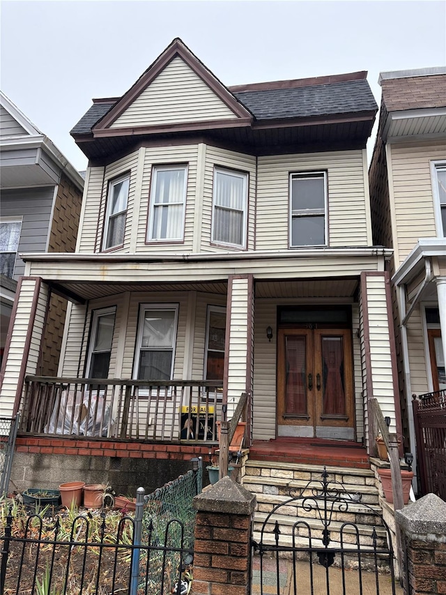 townhome / multi-family property with a porch and french doors