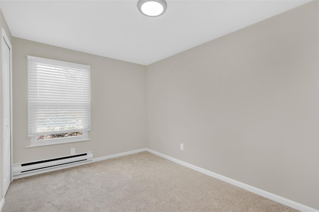 spare room with carpet flooring and a baseboard radiator