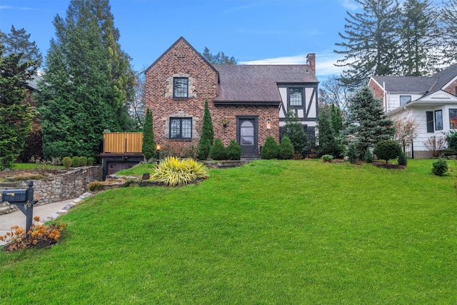 tudor home featuring a front yard