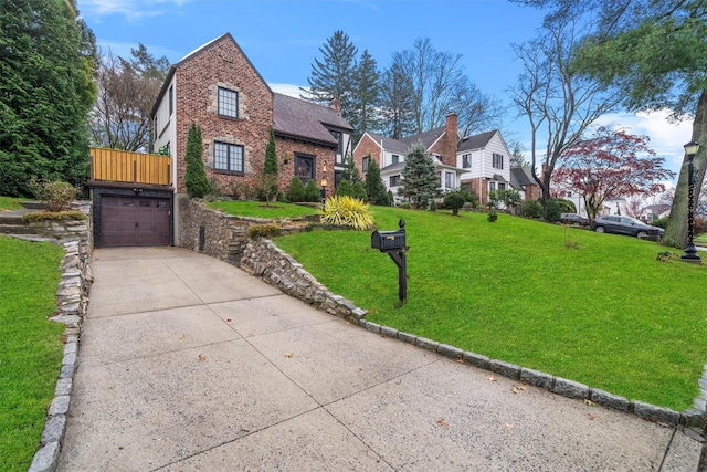 tudor-style house featuring a front yard