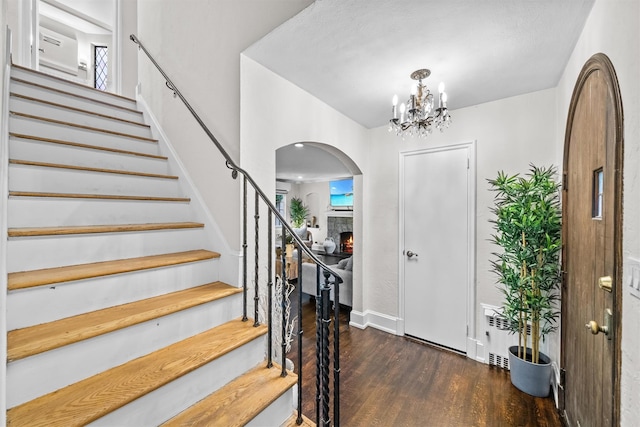 entryway with dark hardwood / wood-style floors and a chandelier