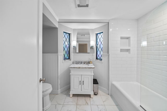 bathroom with vanity, toilet, a bathtub, and wooden walls