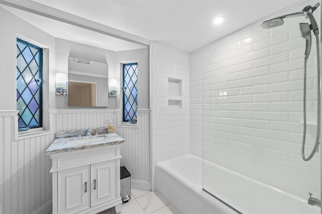 bathroom featuring vanity and tiled shower / bath combo