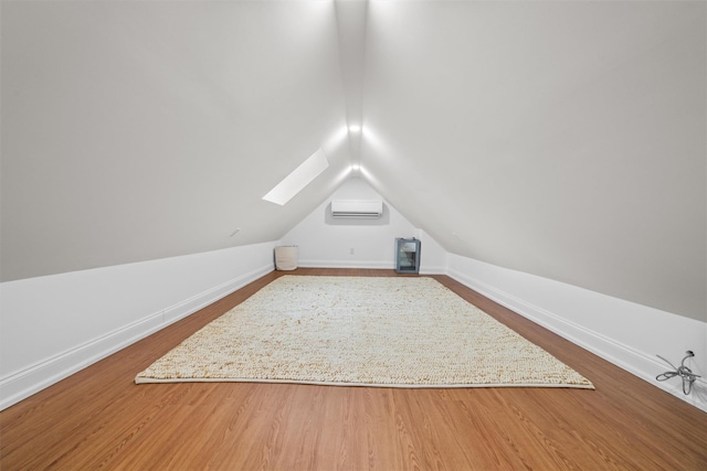 bonus room with hardwood / wood-style floors, lofted ceiling, and a wall mounted AC