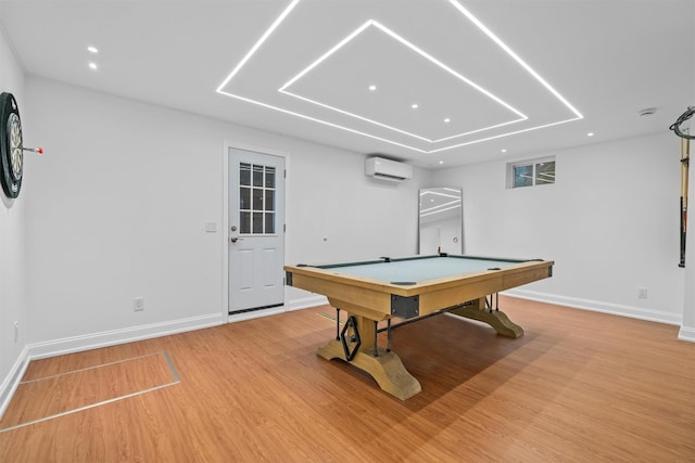 game room with an AC wall unit, billiards, and light wood-type flooring