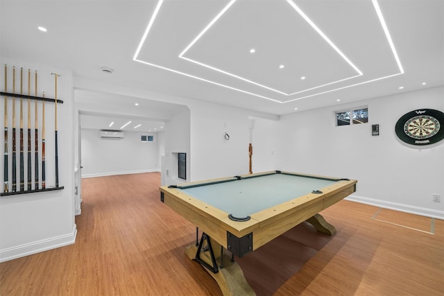 game room with hardwood / wood-style flooring, a wall mounted air conditioner, and pool table