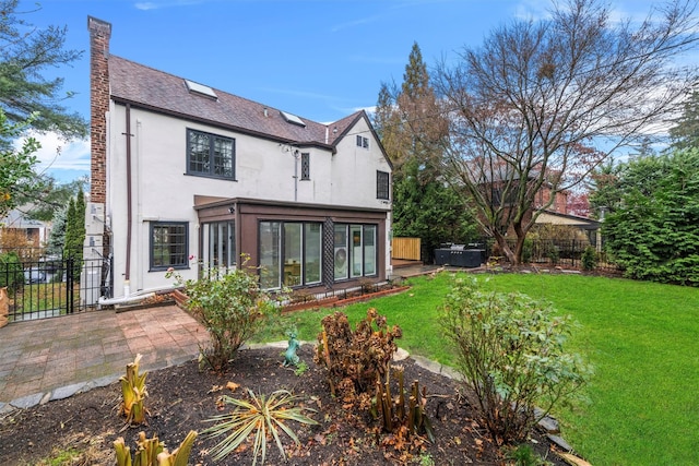 rear view of house featuring a yard