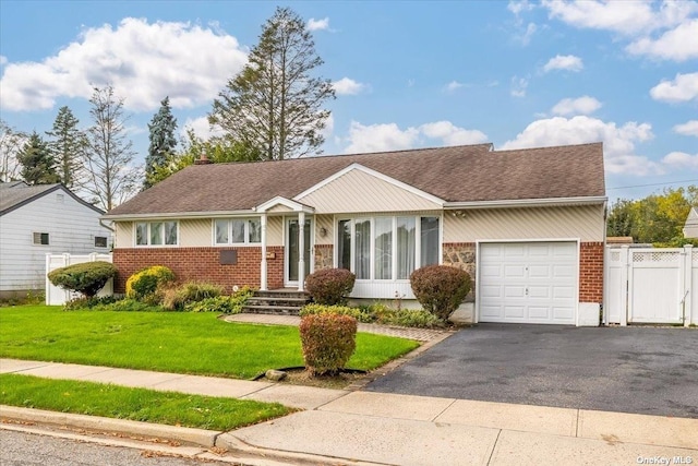 ranch-style home with a front yard and a garage