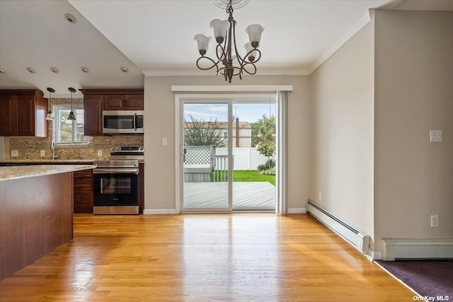 kitchen with stainless steel appliances, plenty of natural light, backsplash, a baseboard radiator, and pendant lighting