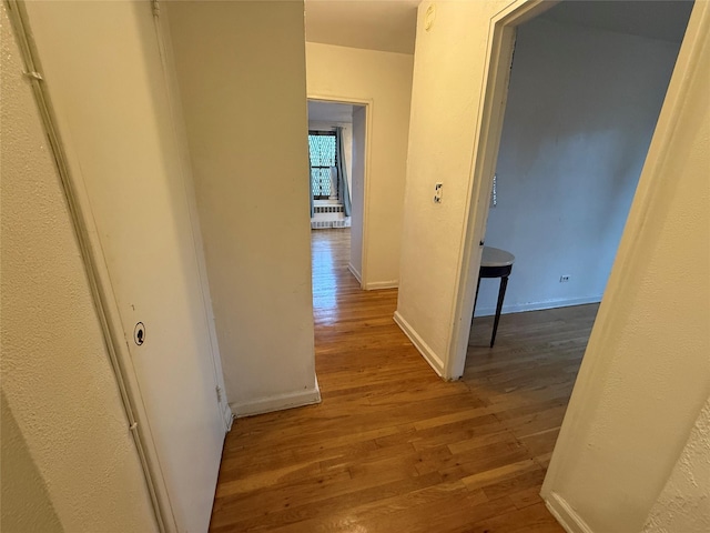 corridor featuring hardwood / wood-style flooring