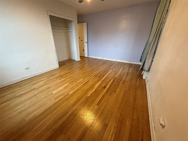 unfurnished bedroom with a closet and light hardwood / wood-style flooring