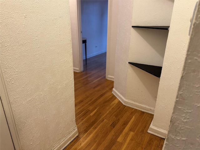 hall with dark wood-type flooring