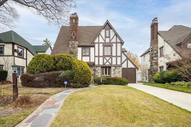 tudor home featuring a front yard