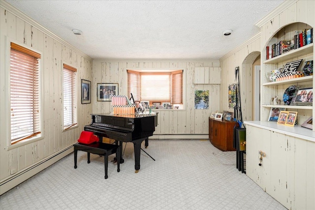 miscellaneous room with light colored carpet, a textured ceiling, and a baseboard heating unit