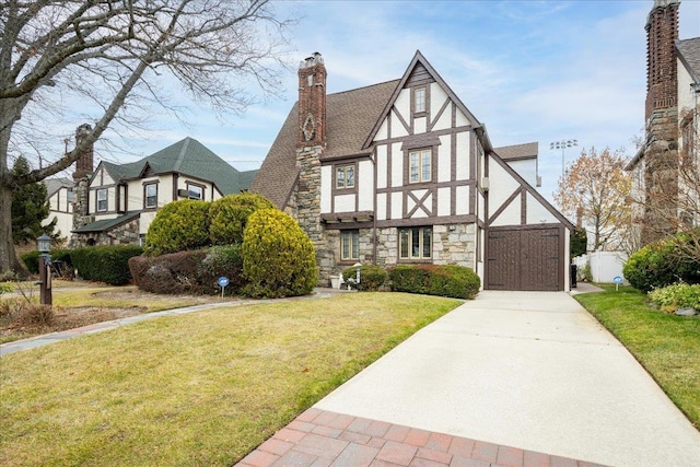 tudor-style house with a front yard