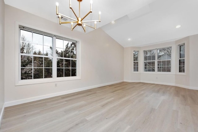 unfurnished living room featuring light hardwood / wood-style flooring, lofted ceiling, and a notable chandelier