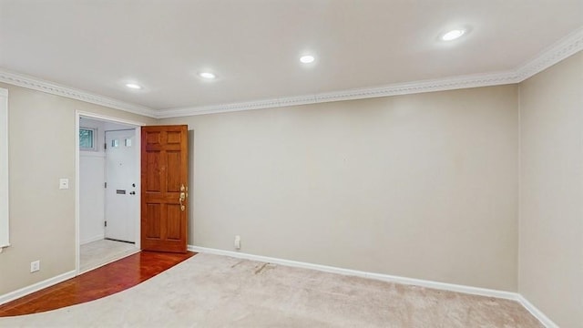 spare room featuring carpet and ornamental molding