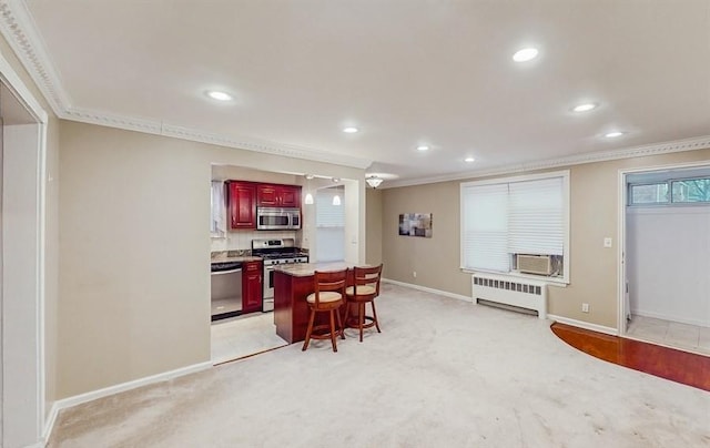 carpeted dining area with radiator heating unit and crown molding