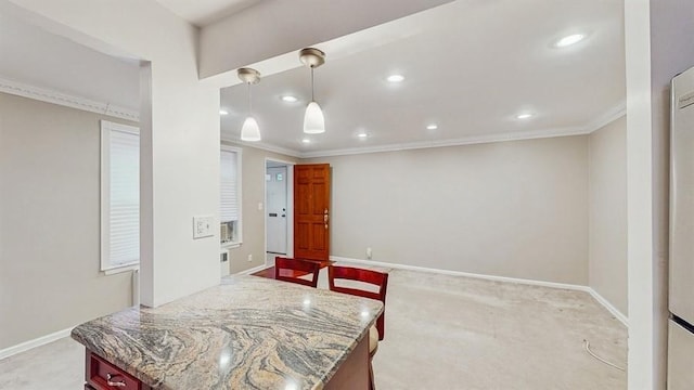 kitchen with light carpet, hanging light fixtures, and ornamental molding