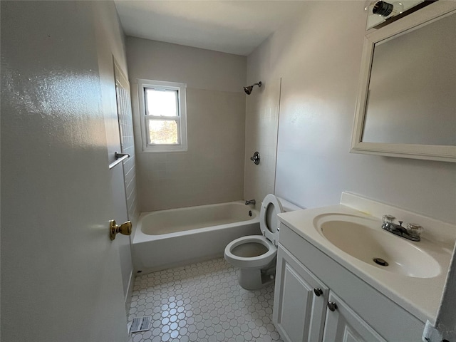 full bathroom with tile patterned flooring, tiled shower / bath combo, toilet, and vanity