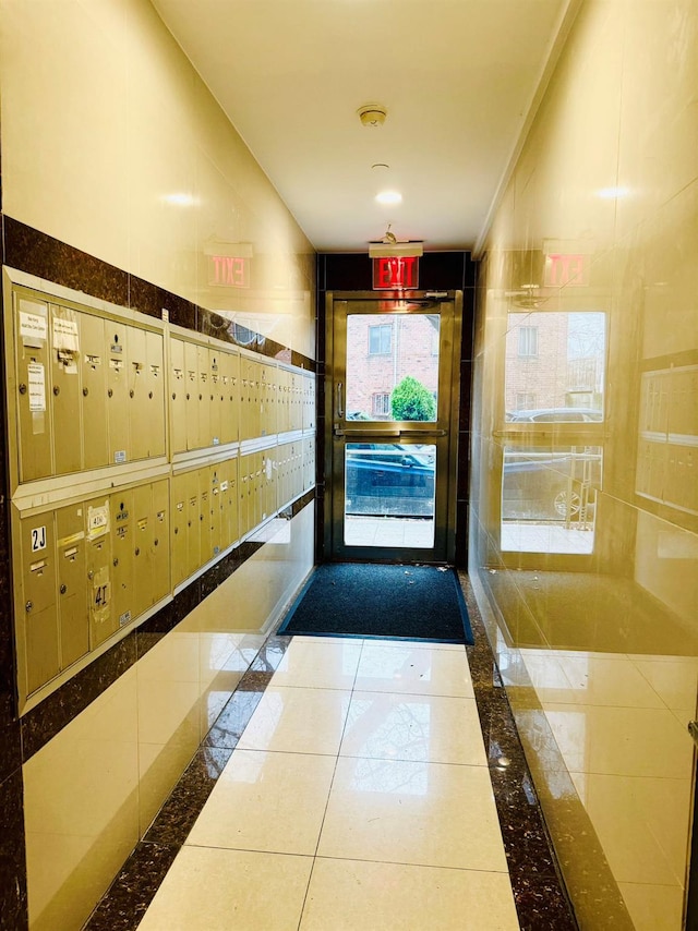 interior space featuring mail boxes and tile patterned floors