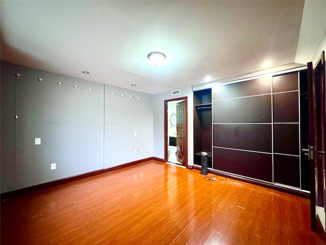 spare room featuring wood-type flooring