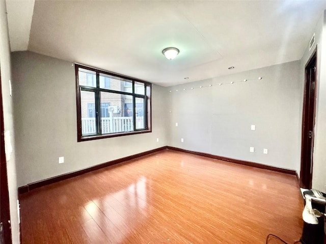 unfurnished room with hardwood / wood-style floors