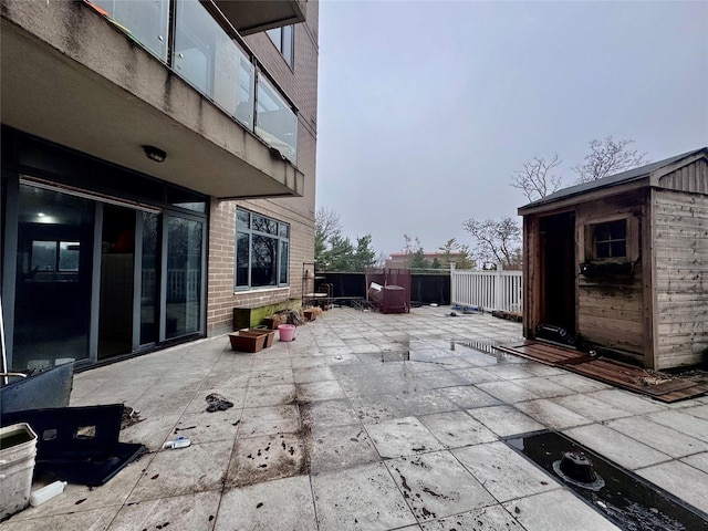 view of patio / terrace featuring a storage unit