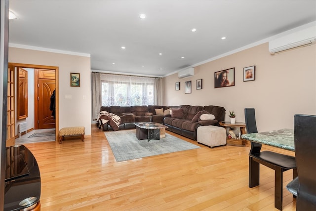 living room with an AC wall unit, light hardwood / wood-style floors, and ornamental molding