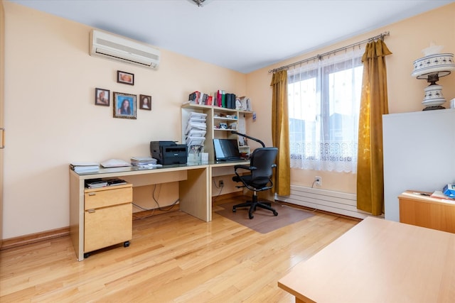 office space with a baseboard radiator, a wall mounted air conditioner, and light wood-type flooring