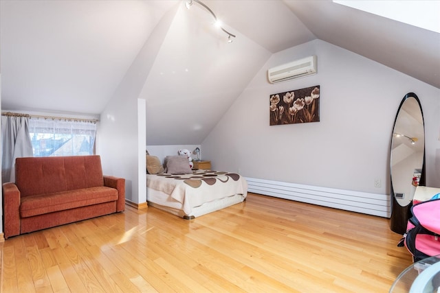 bedroom with vaulted ceiling, a wall mounted air conditioner, and hardwood / wood-style flooring