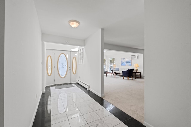 carpeted foyer featuring a baseboard heating unit, tile patterned flooring, a wall unit AC, and baseboards