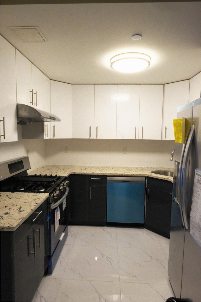 kitchen featuring light stone countertops, white cabinetry, sink, and stainless steel appliances