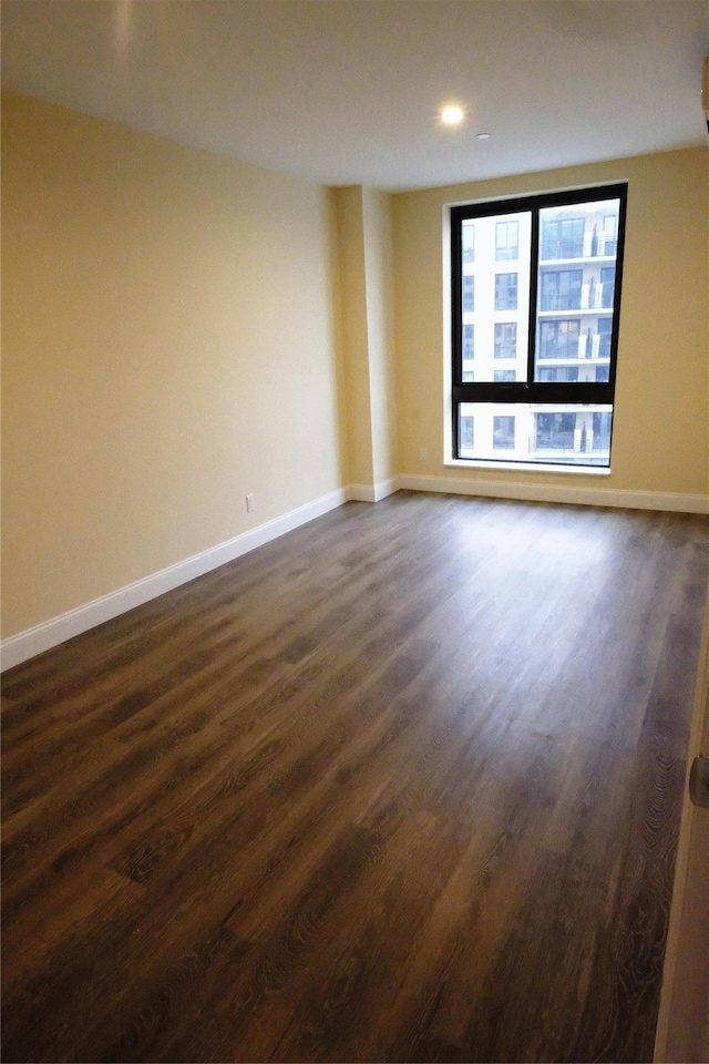 spare room featuring dark hardwood / wood-style floors