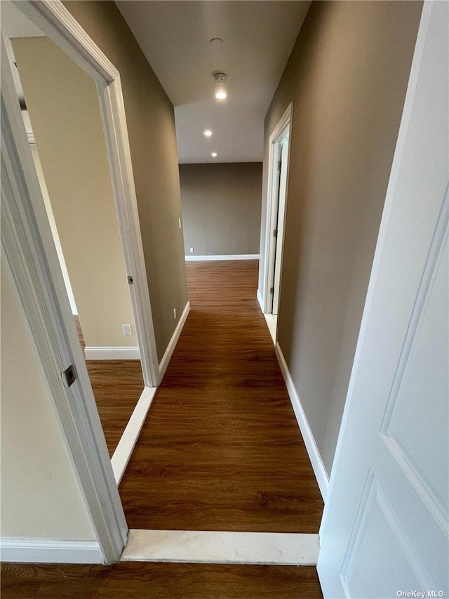 hallway featuring dark hardwood / wood-style flooring