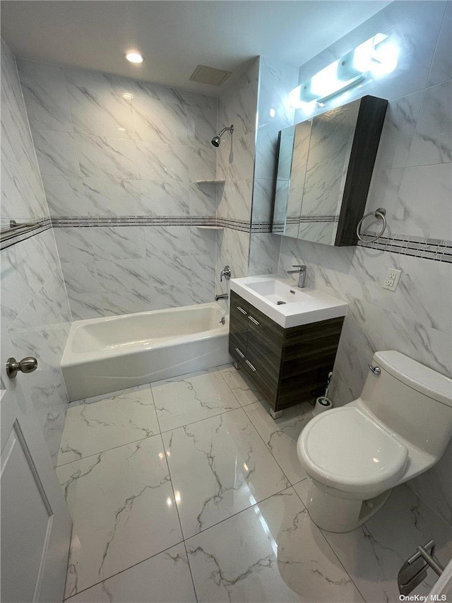 full bathroom featuring vanity, shower / bathtub combination, toilet, and tile walls